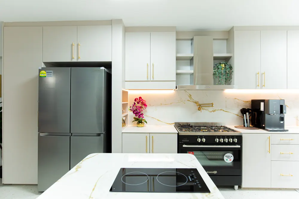 A completed HDB kitchen with fitted cabinetry and a sintered stone countertop